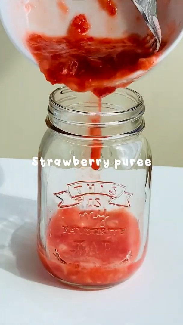 Add strawberry puree to a glass jar