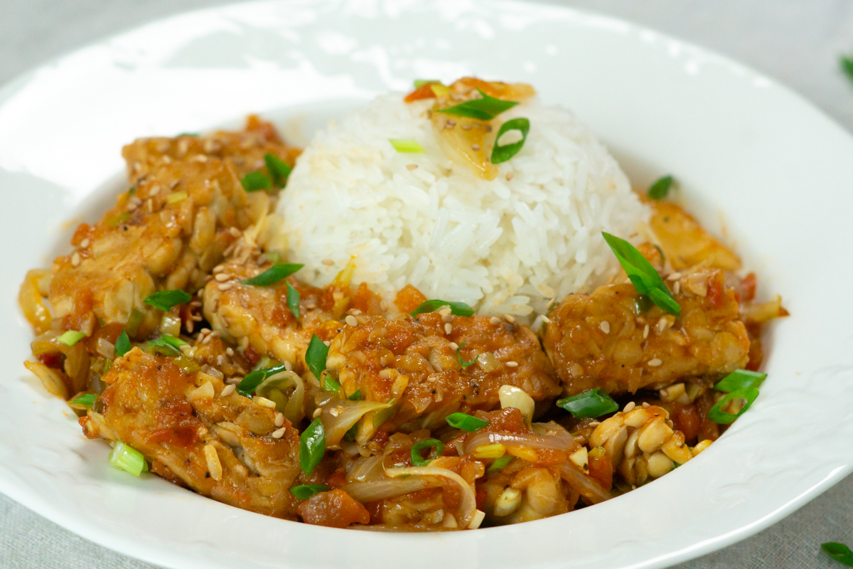 a plate of sweet and sour tempeh with rice