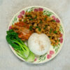 a plate of tofu bulgogi with rice, kimchi and cabbage
