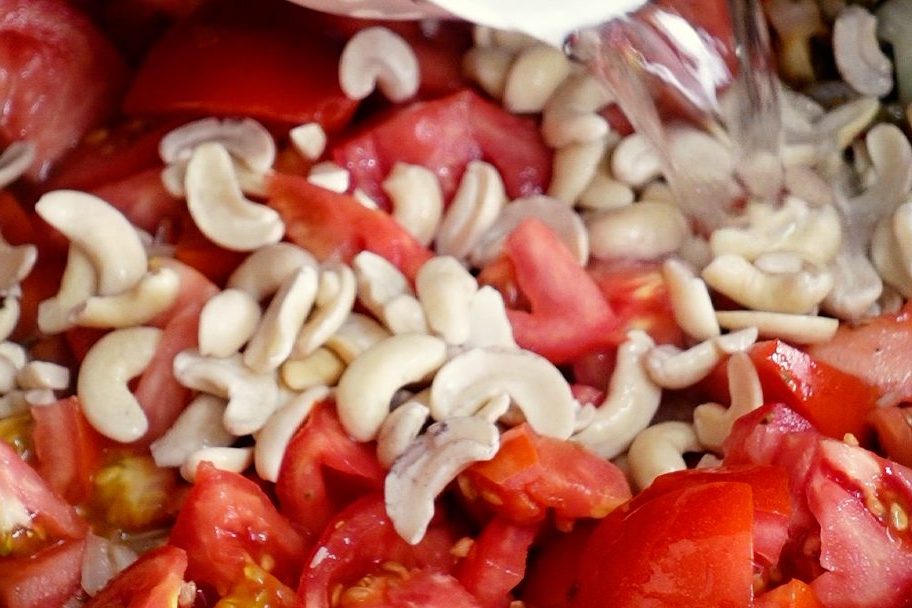 Add the tomatoes and cashews