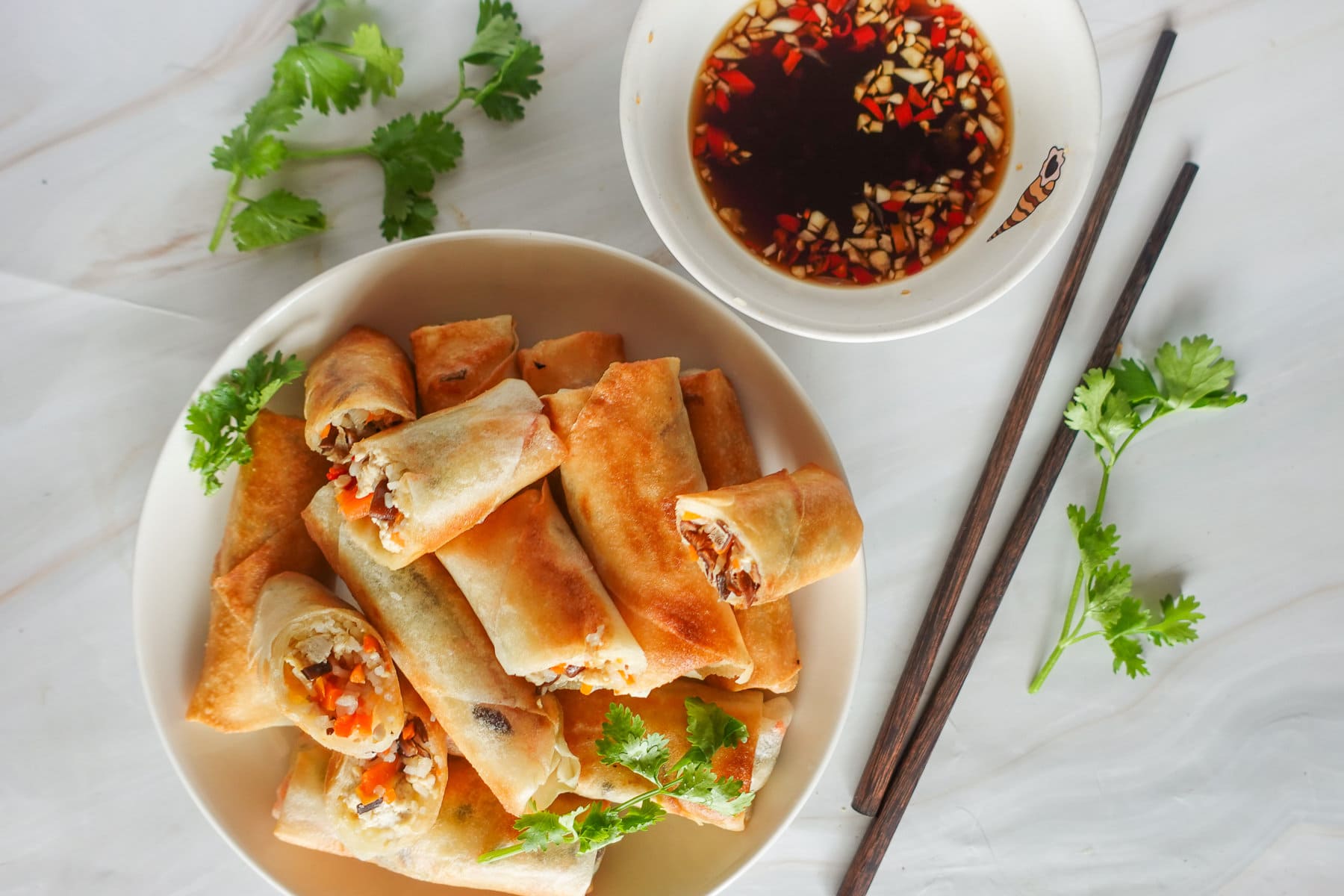 A plate of Vegan Egg Rolls paired with the flavorful dipping sauce