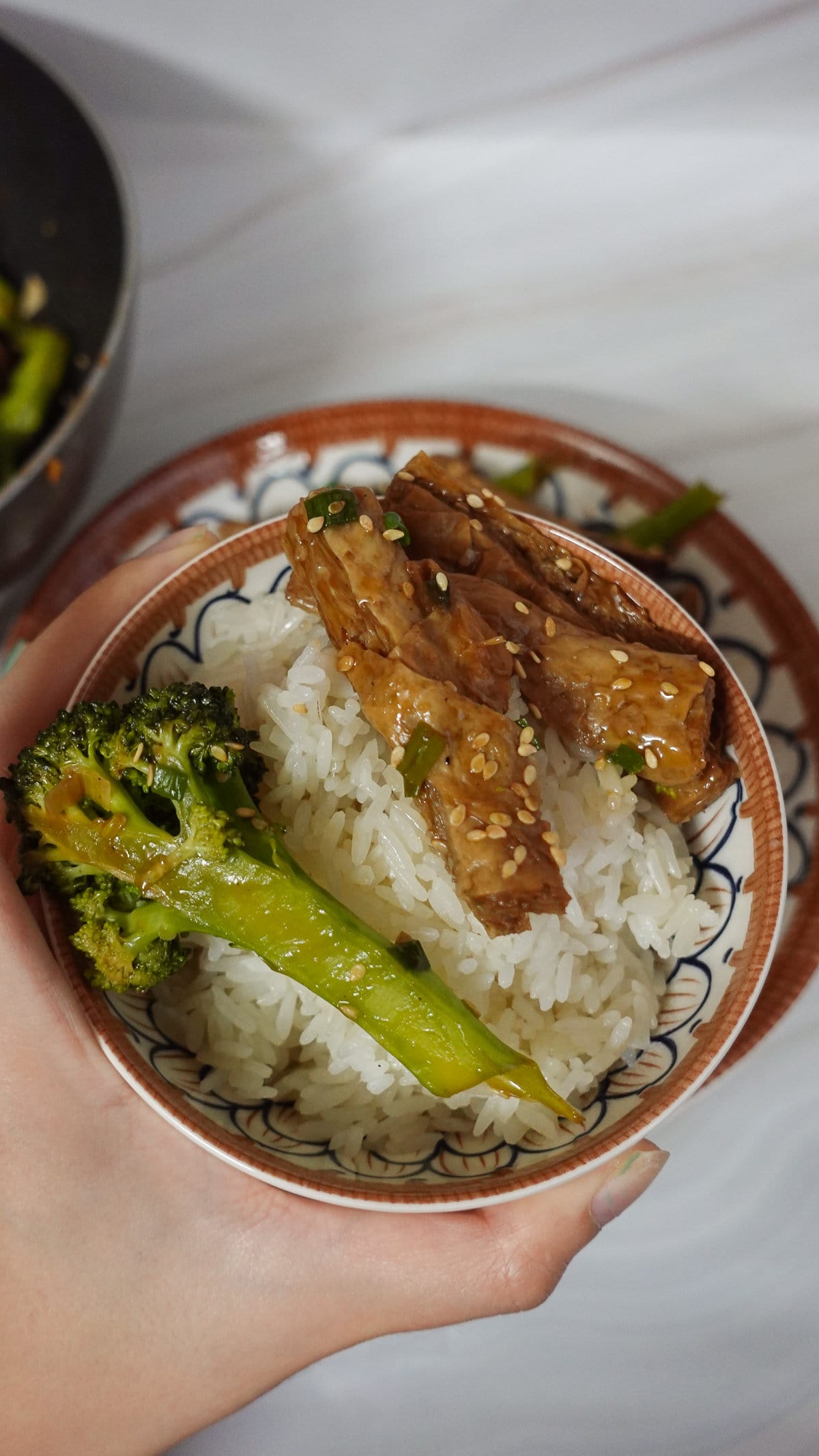 a bowl of rice with vegan beef and broccoli