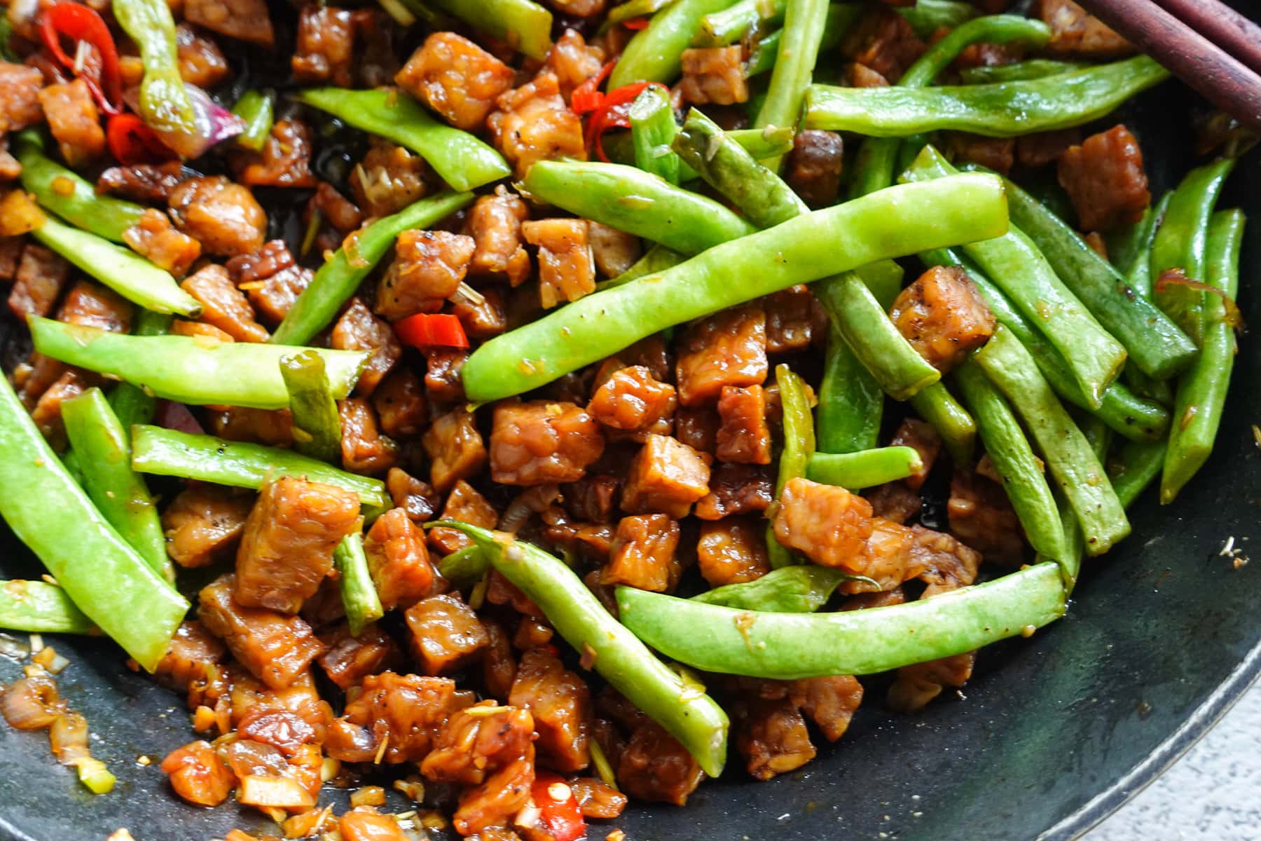 Stir fry the aromatics with green beans and aromatics