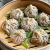 vegan soup dumplings in a bamboo steamer