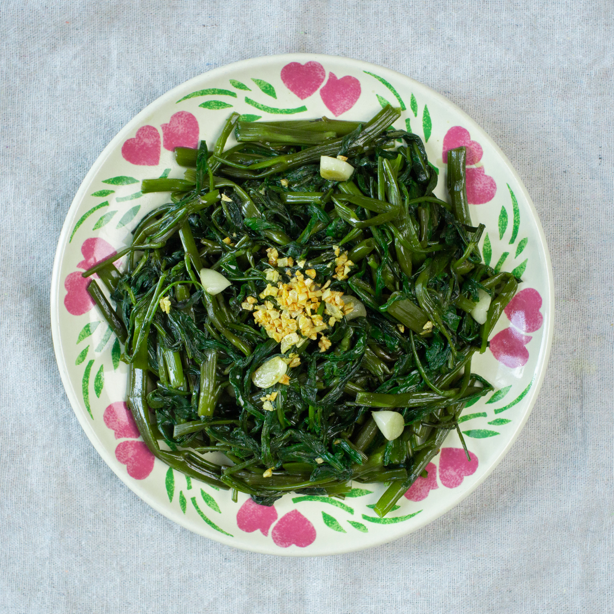 a plate of stir fried morning glory