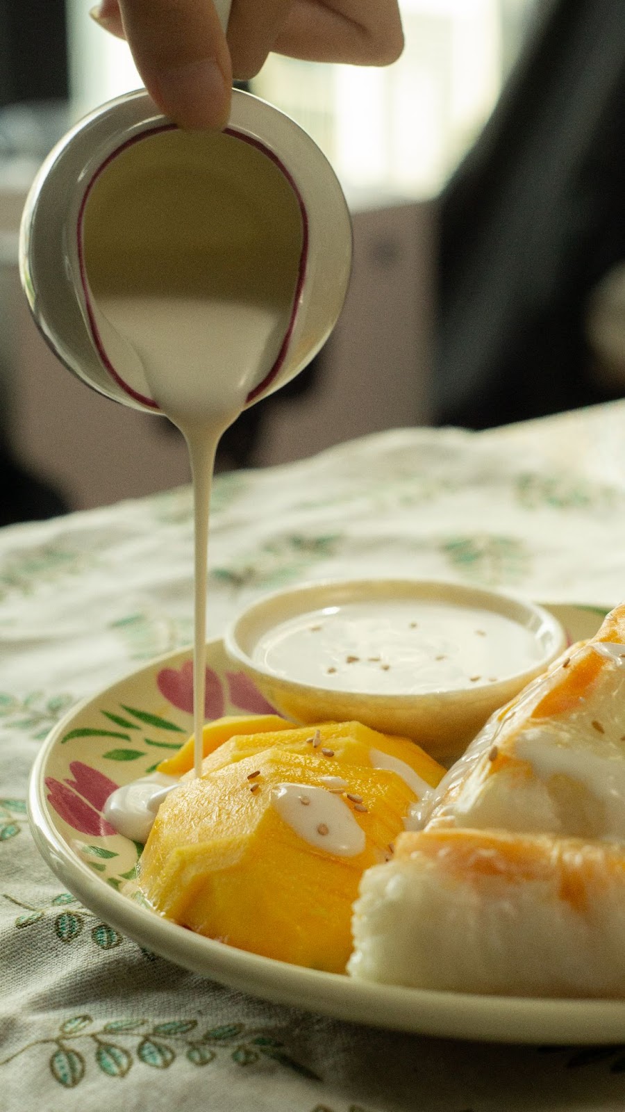 Pour the coconut sauce over the mango and sticky rice rolls!