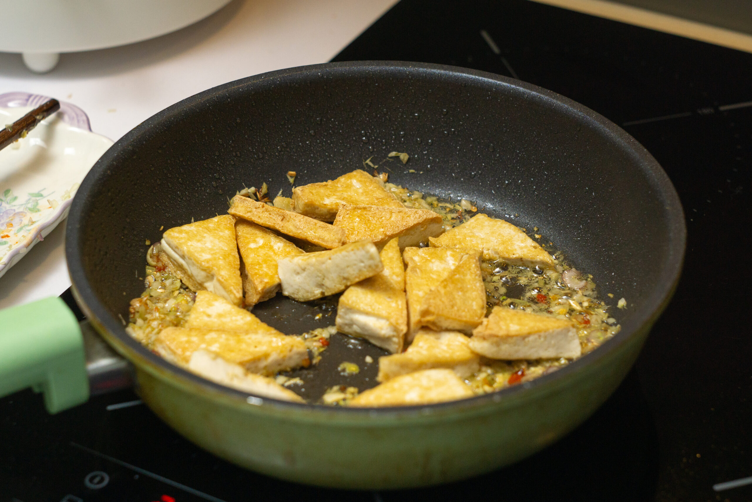mixing the tofu with the aromatics