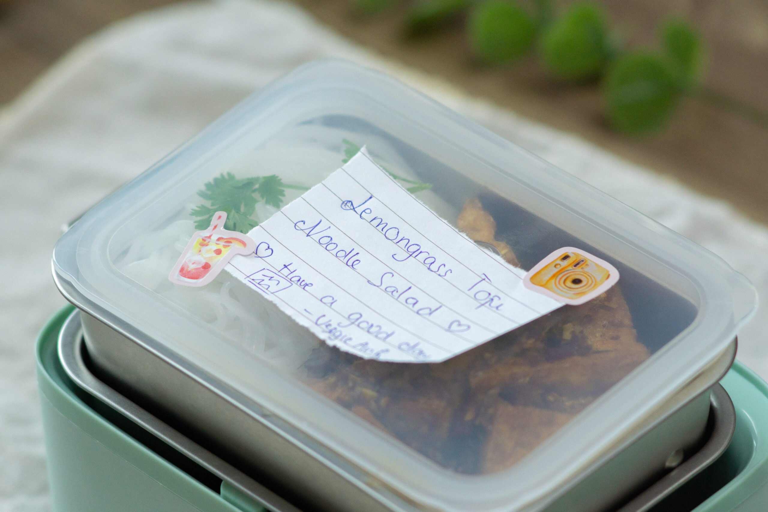 a lunchbox with a note on top