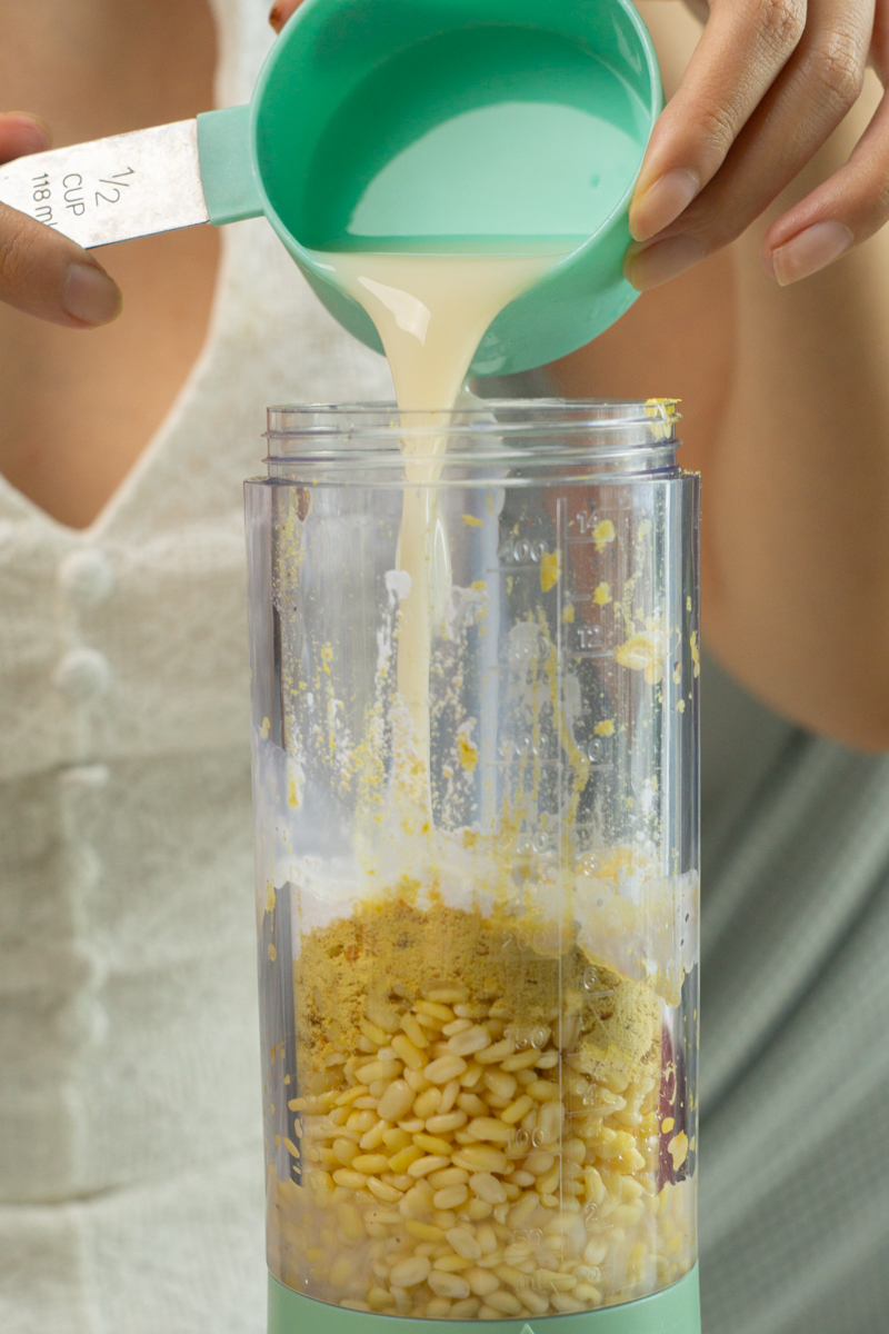 adding plant milk to a blender