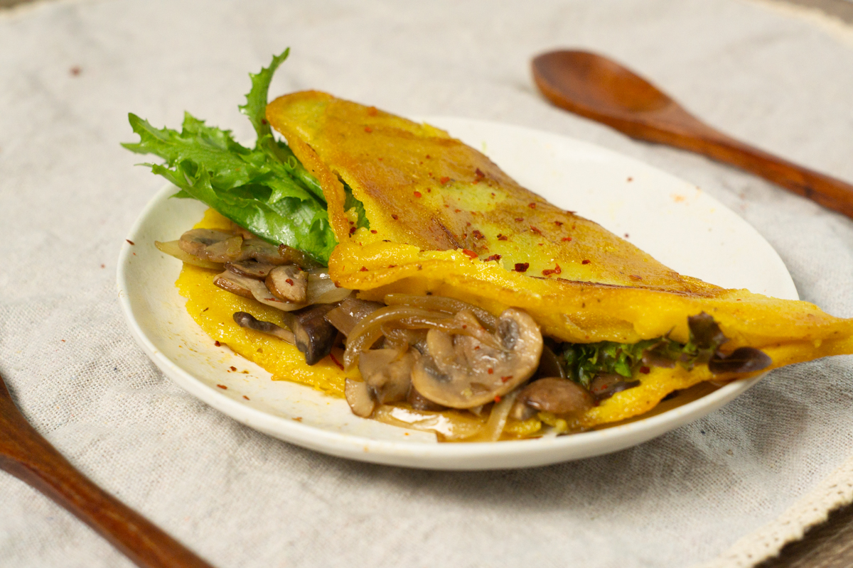 vegan mung bean egg filled with stir-fried shiitake and leafy greens