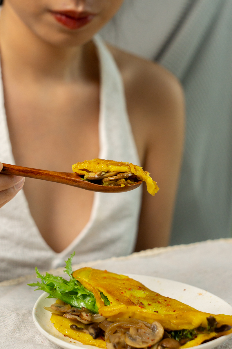 a spoon-full of vegan mung bean egg and fillings