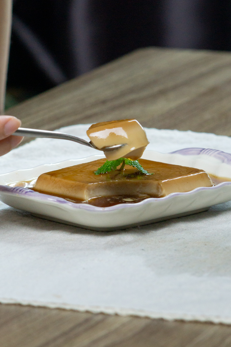 spooning a piece of banh flan