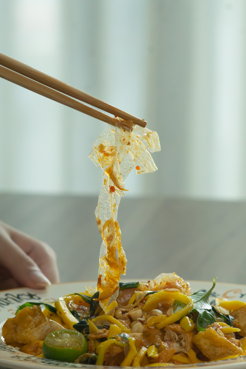 picking up a piece of banh trang