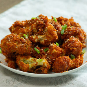 a plate full of gochujang cauliflower drumsticks