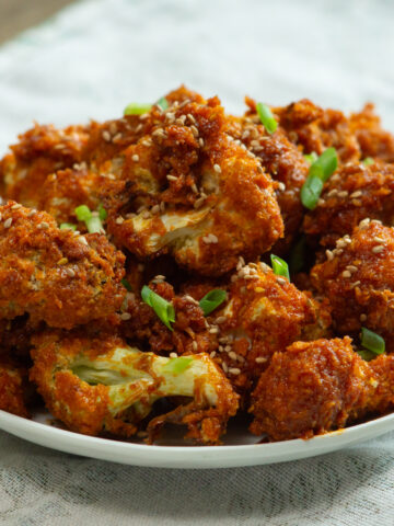 a plate full of gochujang cauliflower drumsticks