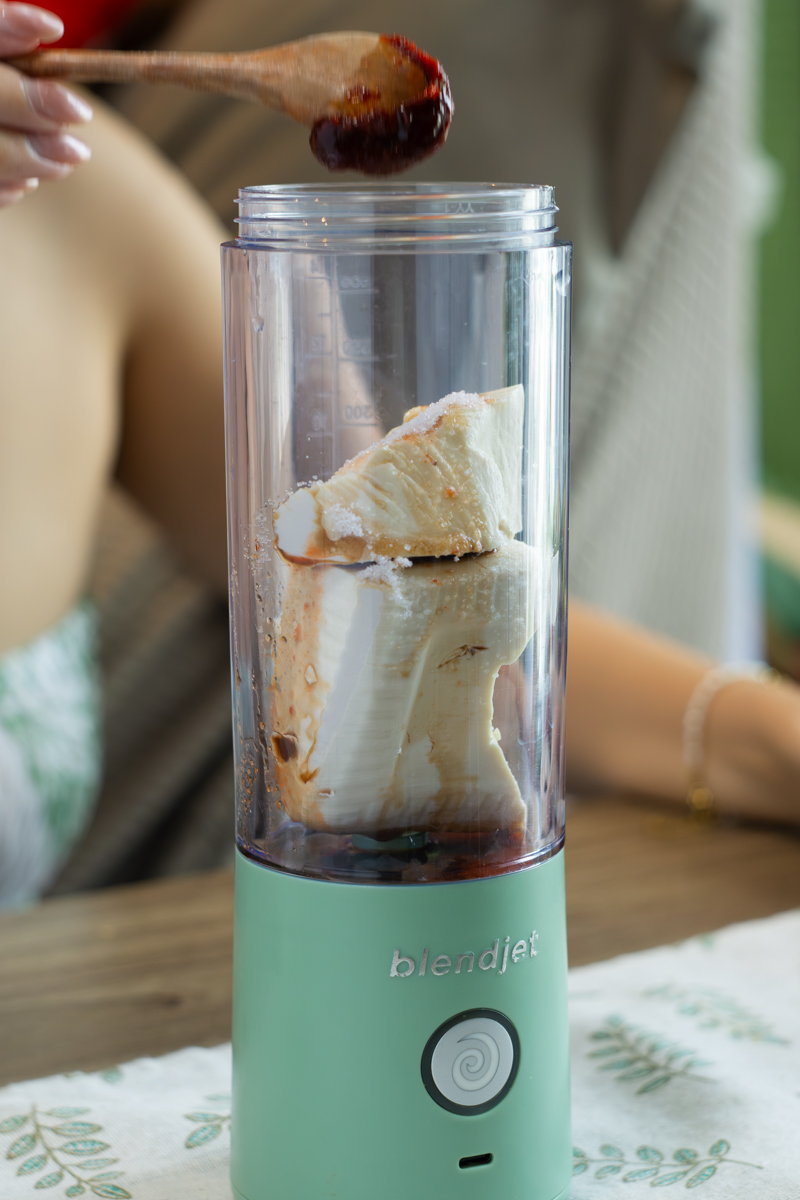 adding ingredients into a blender