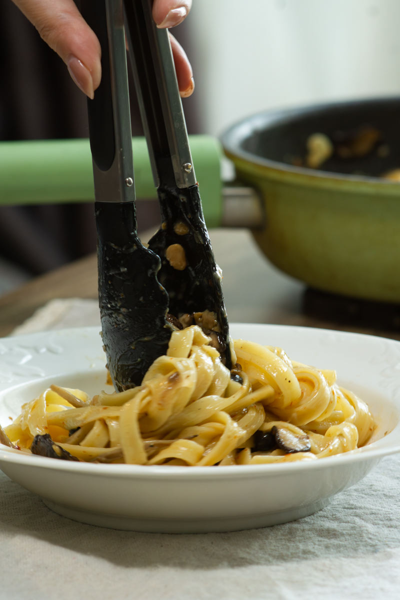 put miso mushroom pasta on a plate
