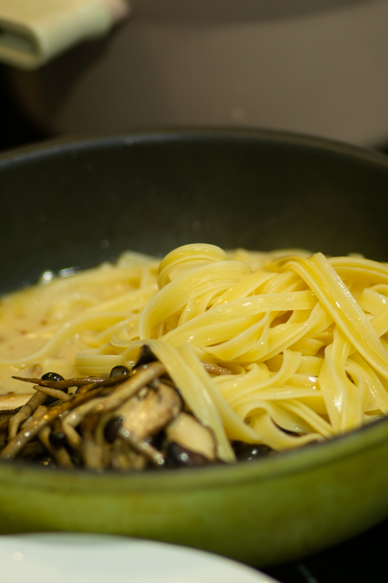 adding cooked pasta to the sauce